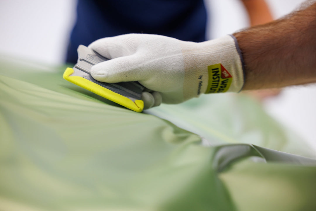 Wing-tip Cornergame strip in use on a squeegee during vinyl wrap