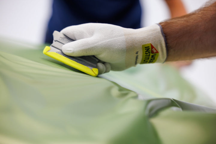 Wing-tip Cornergame strip in use on a squeegee during vinyl wrap