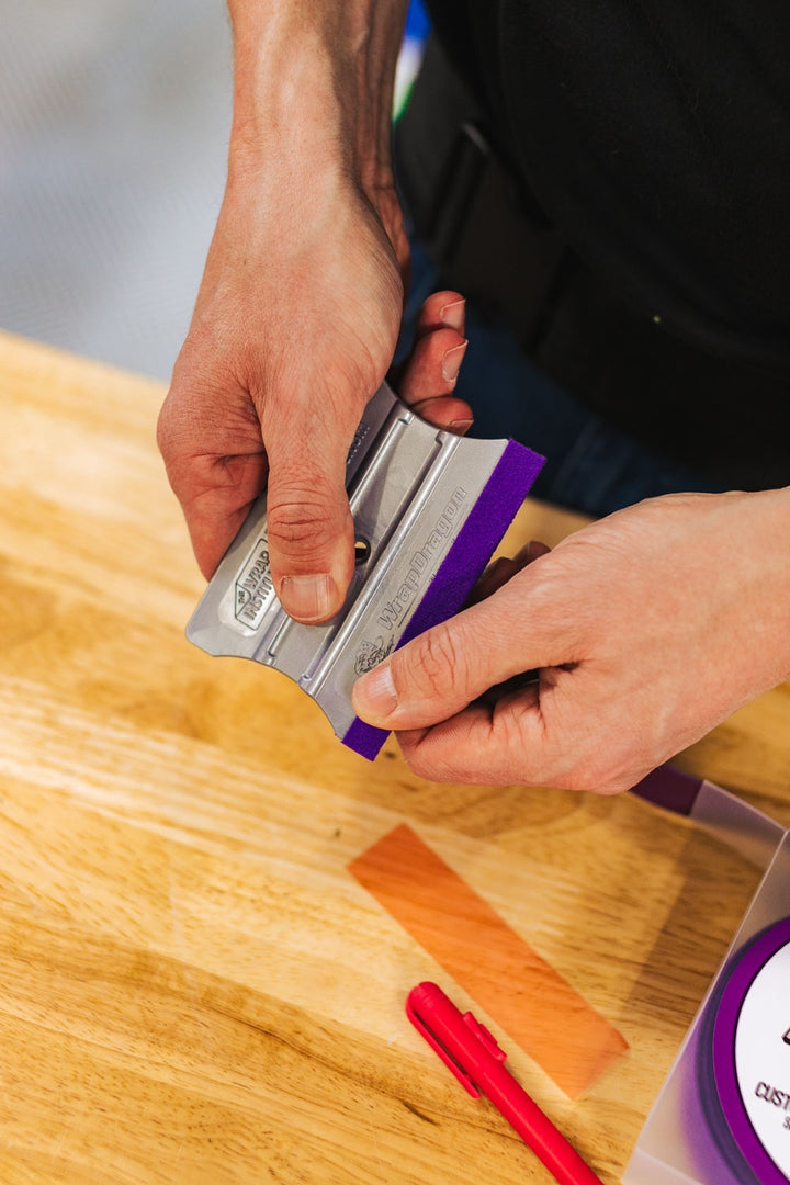 Applying Monkey Tails buffer strip to a squeegee edge